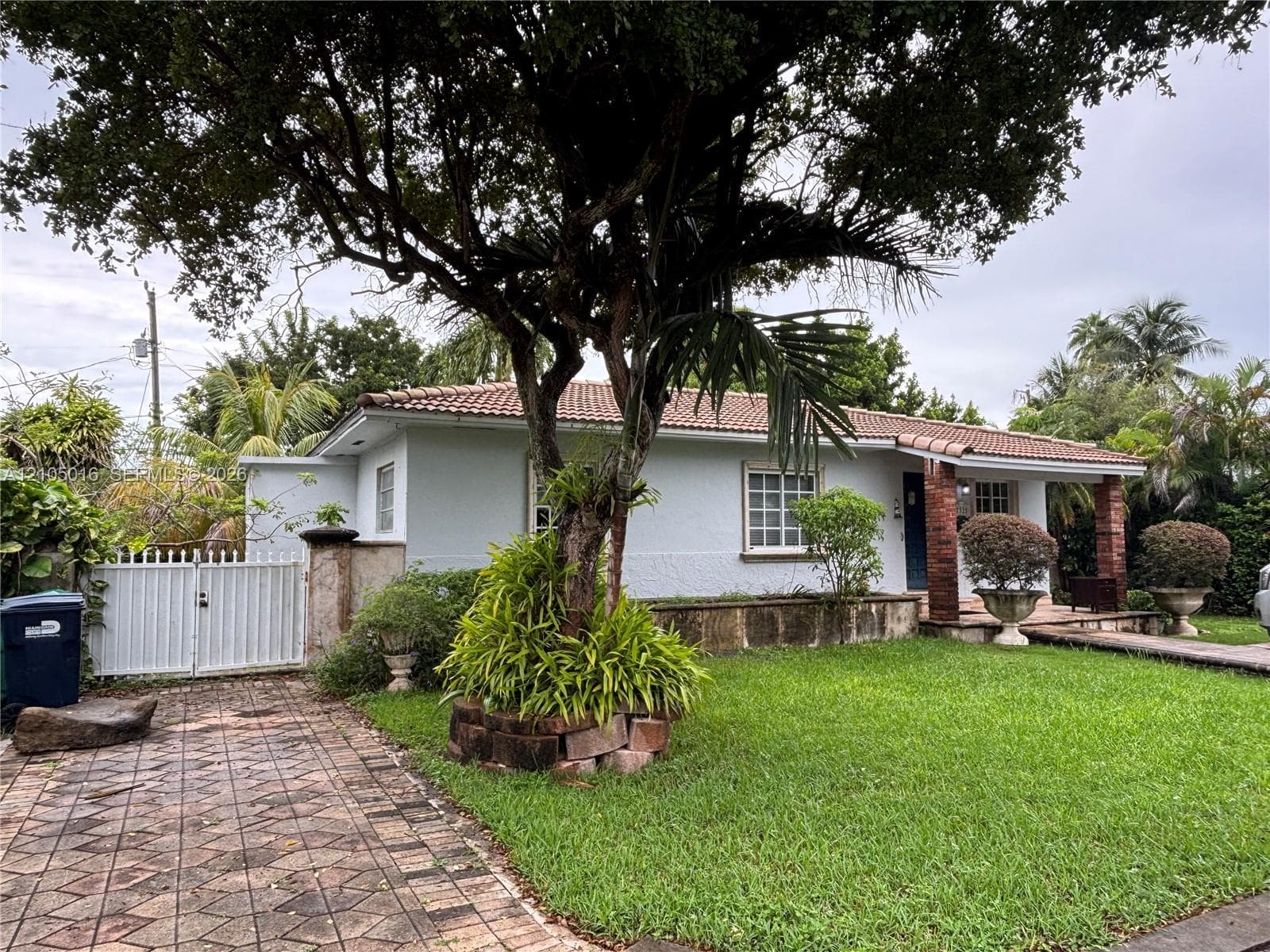 White stucco exterior with a terra cotta tile roof