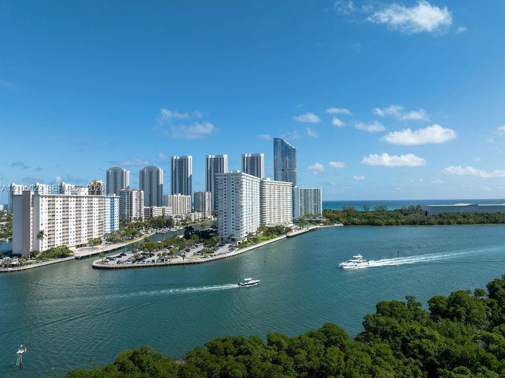 Waterfront city setting with numerous high-rise buildings and ample green space