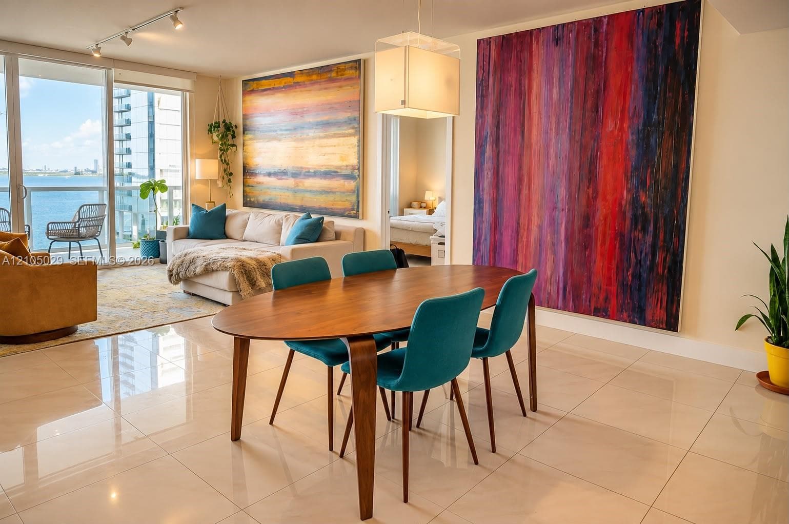 Open-concept area featuring polished tile flooring, floor-to-ceiling glass doors, adjustable track lighting, and a box-style pendant light fixture
