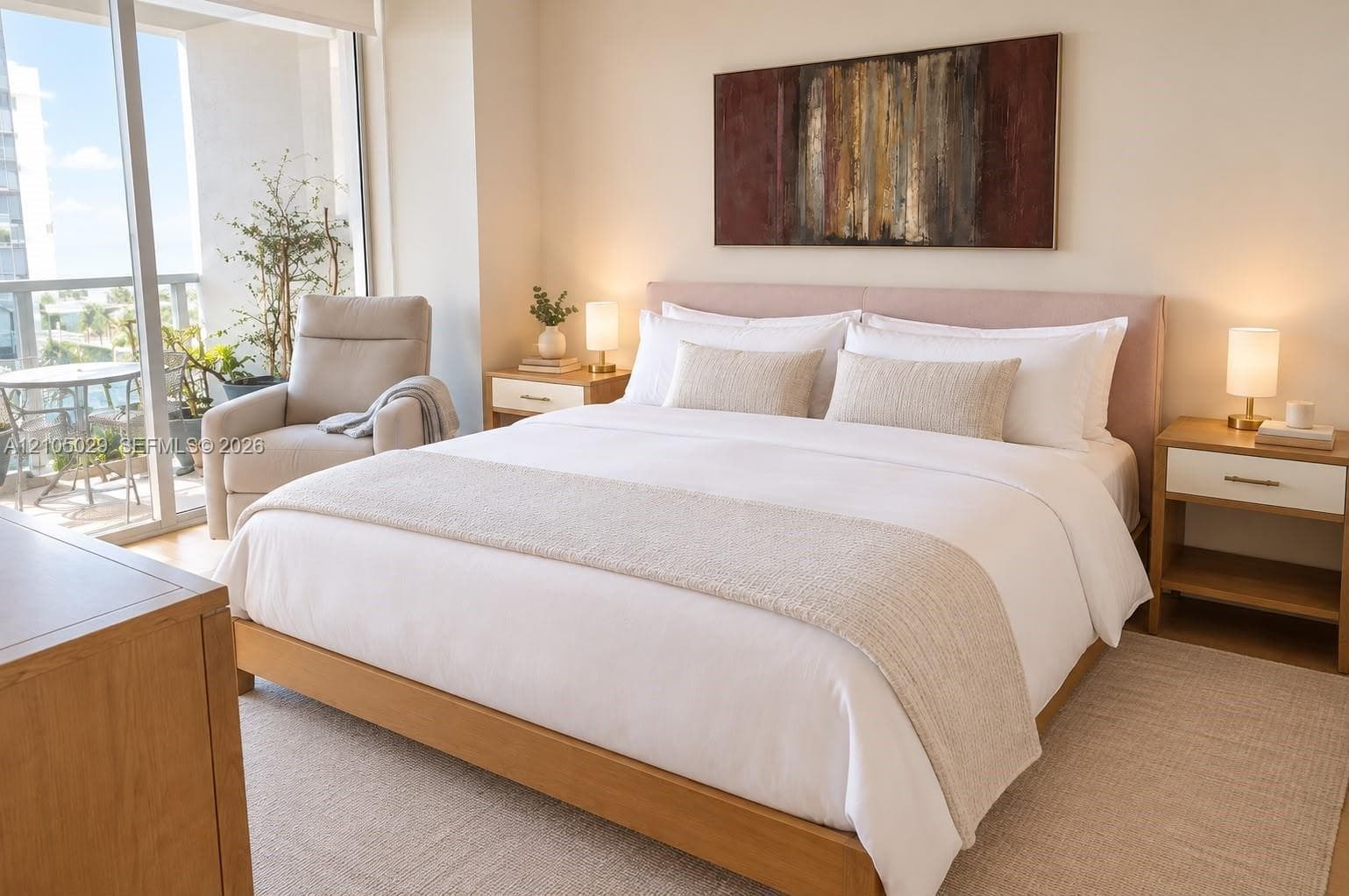Neutral-toned room featuring wood-finish flooring, floor-to-ceiling glass sliding doors, and a private exterior balcony