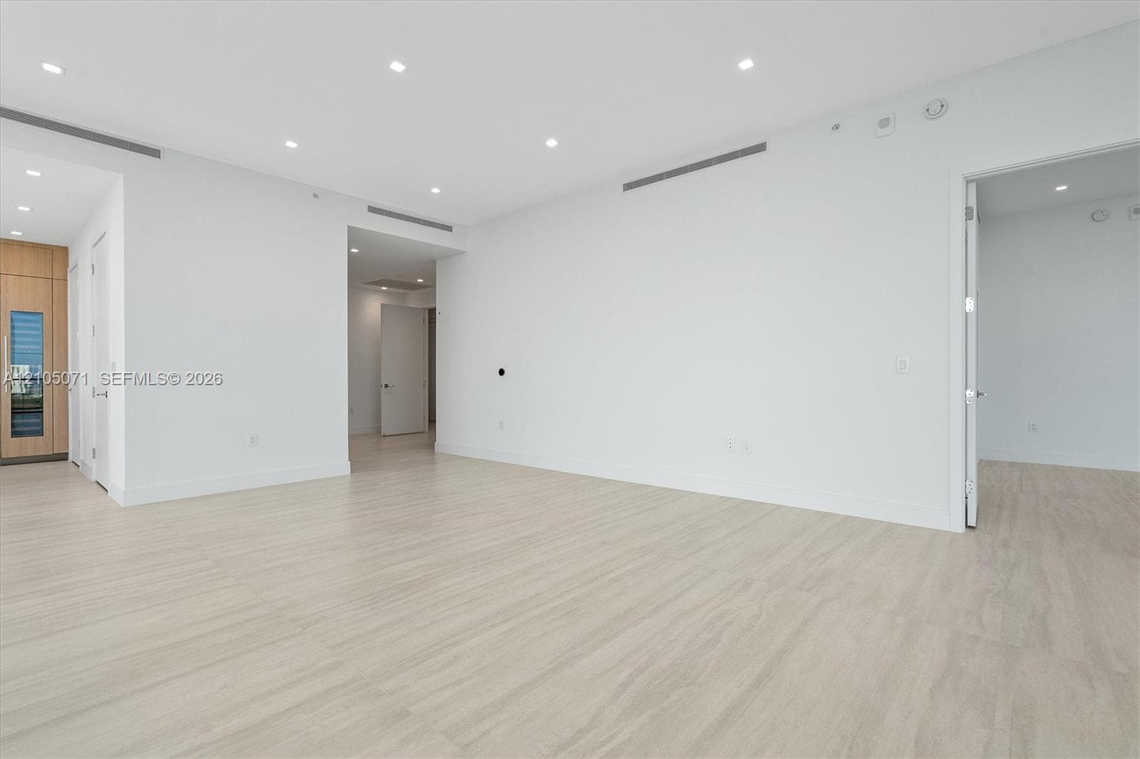 Interior space featuring light-toned wood-finish flooring, recessed lighting, and built-in linear ceiling diffusers