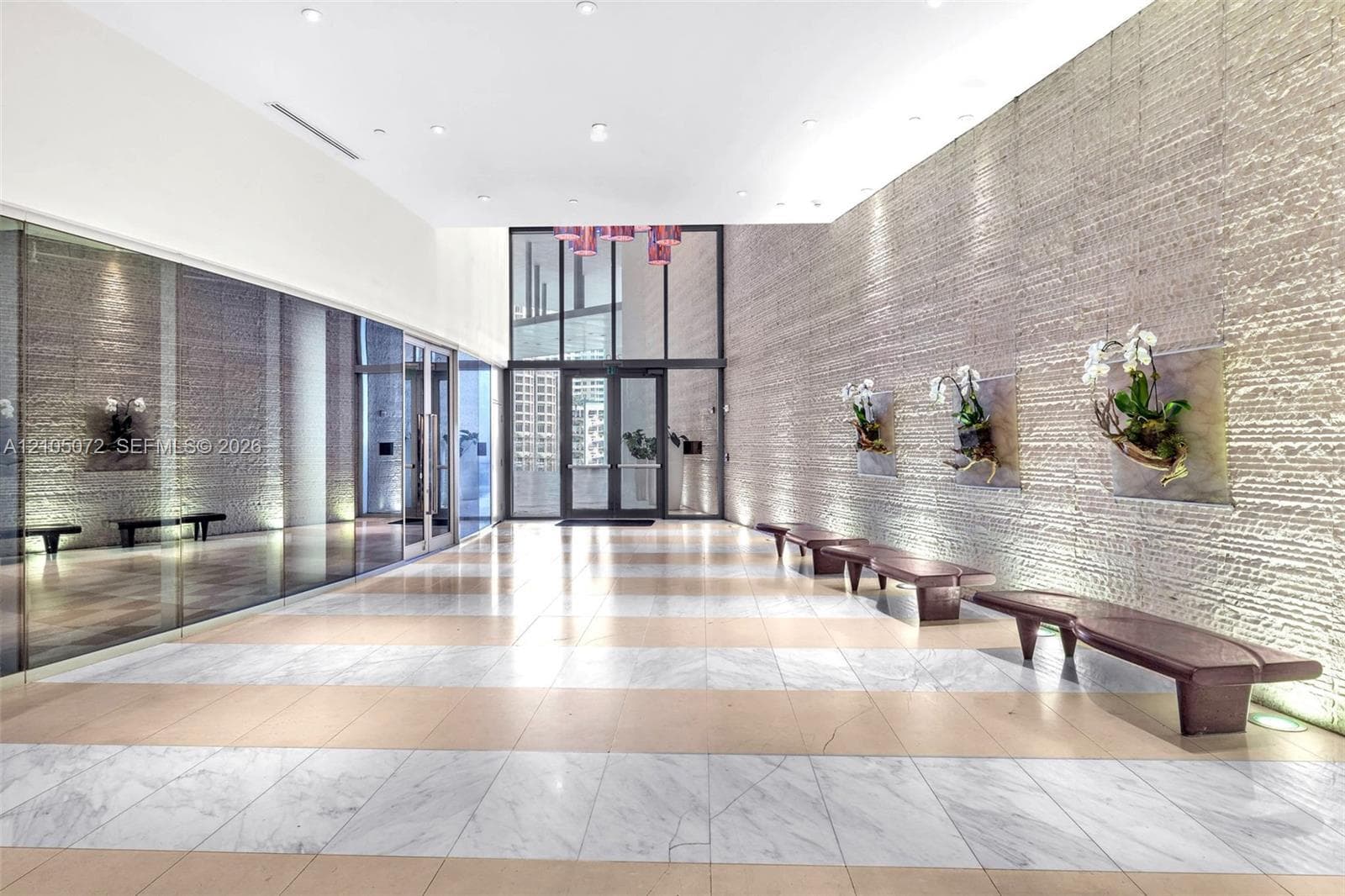Epic Residences lobby with stone-clad walls and bench seating.