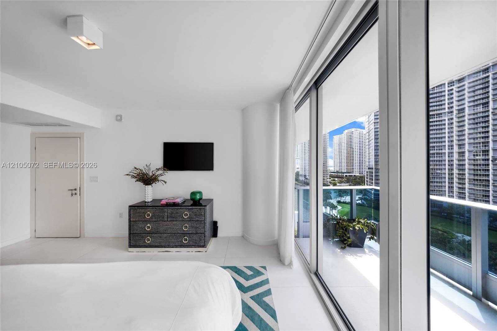 Primary bedroom with large sliding glass doors and direct access to its upper terrace.
