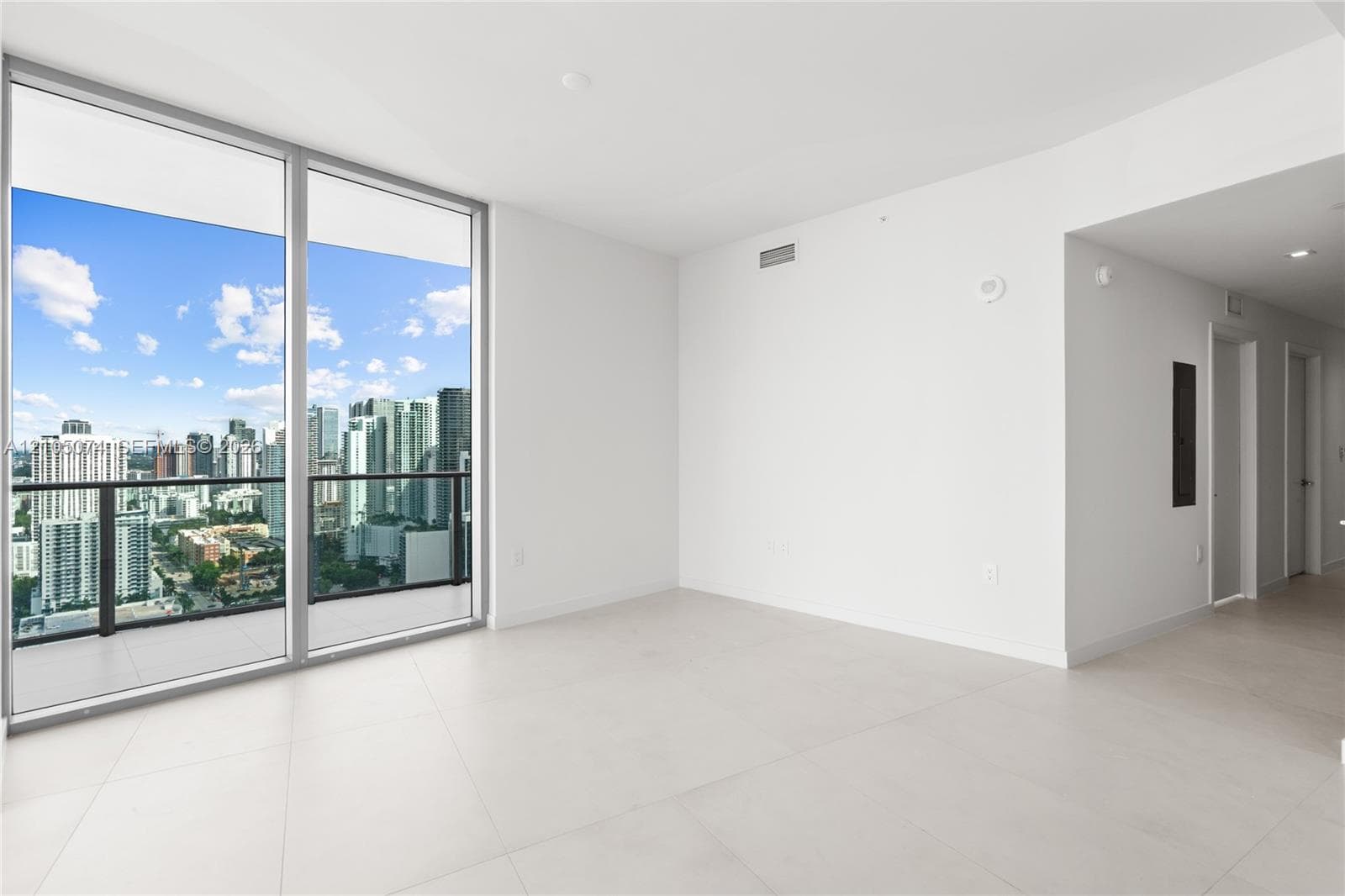 Covered balcony with large-format tile flooring and a glass-paneled railing