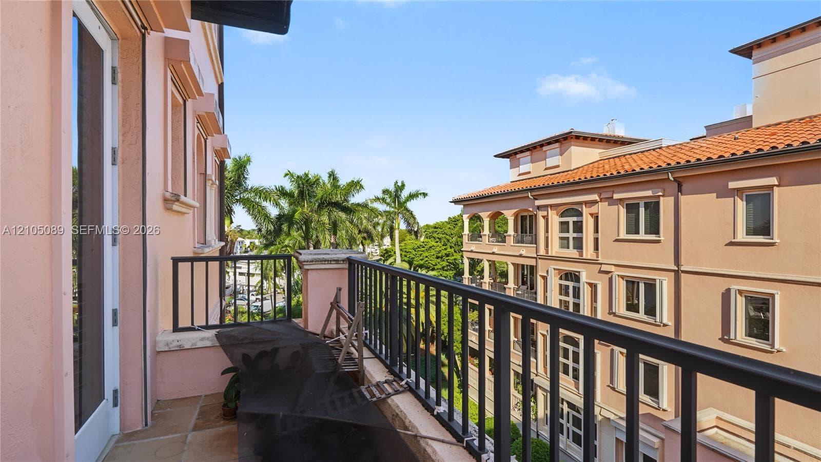 Private balcony with stone flooring and a black metal railing