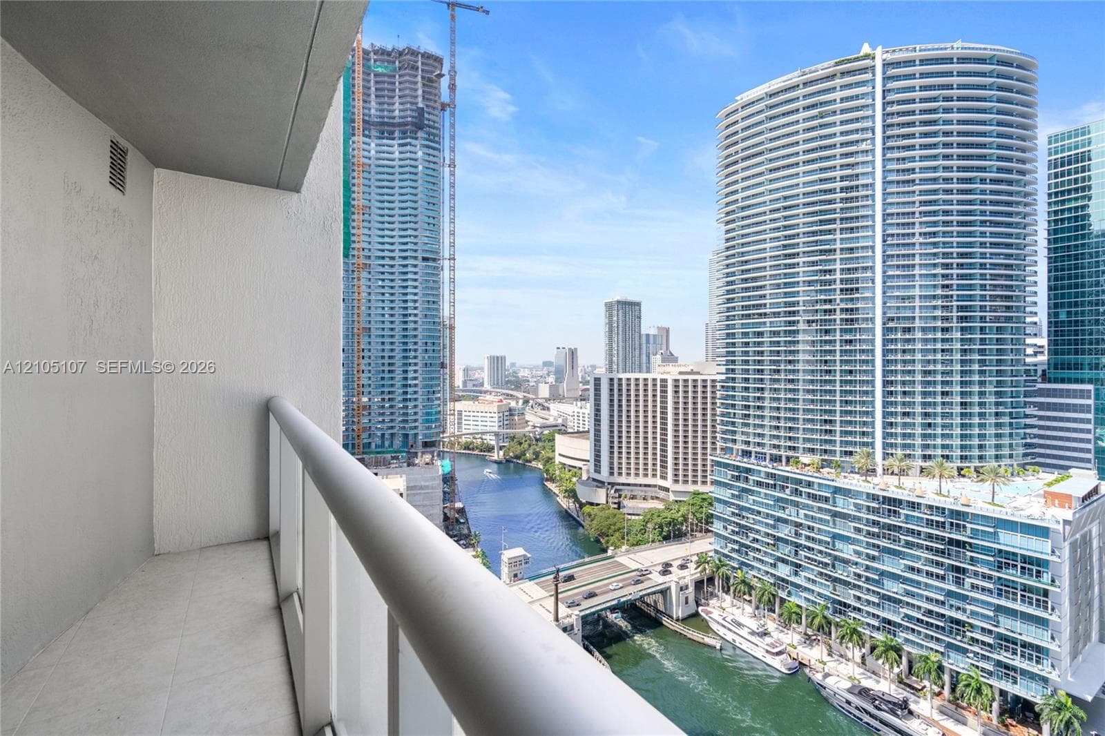 Balcony with tile flooring and a white railing