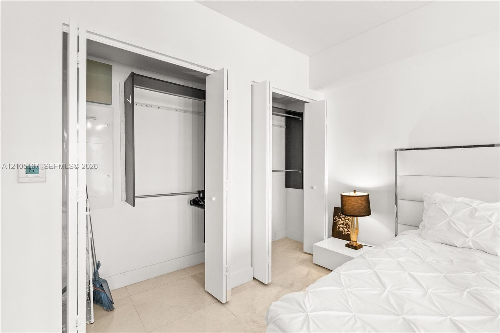 White walls with built-in closets featuring bi-fold doors