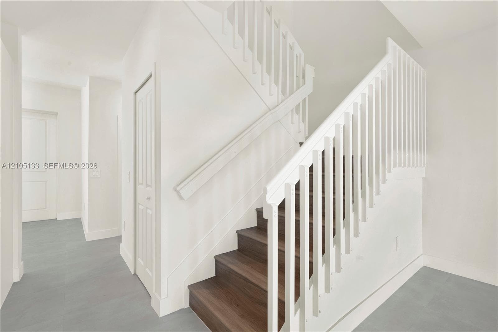 Contemporary staircase with wood-finish treads and white risers