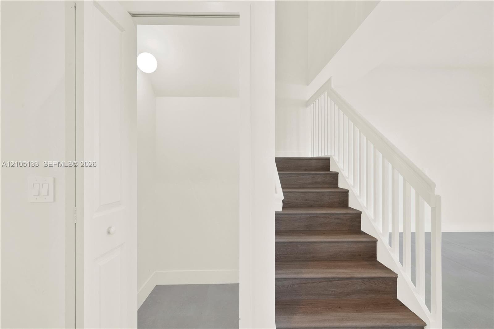 Staircase with wood-finish treads and white balusters