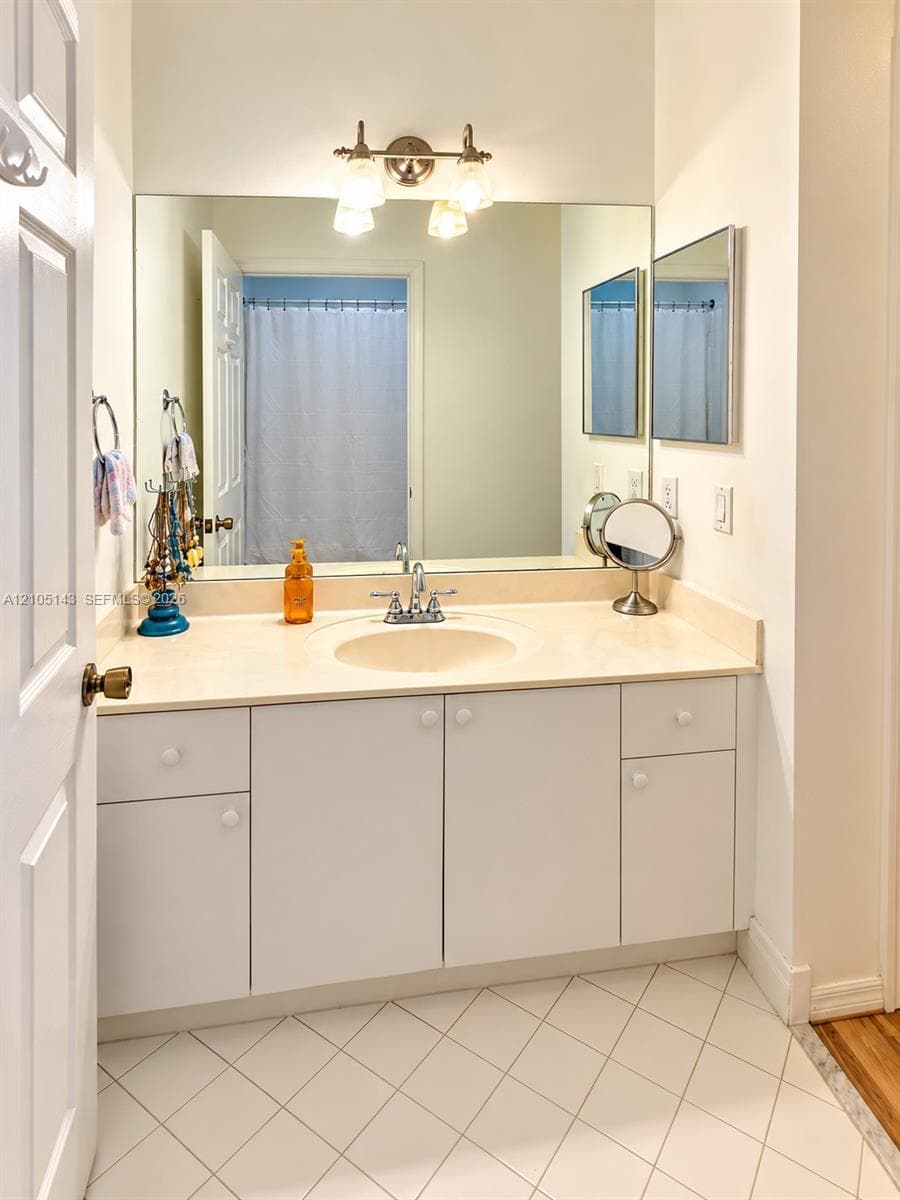 Vanity with an integrated sink and light-toned countertop