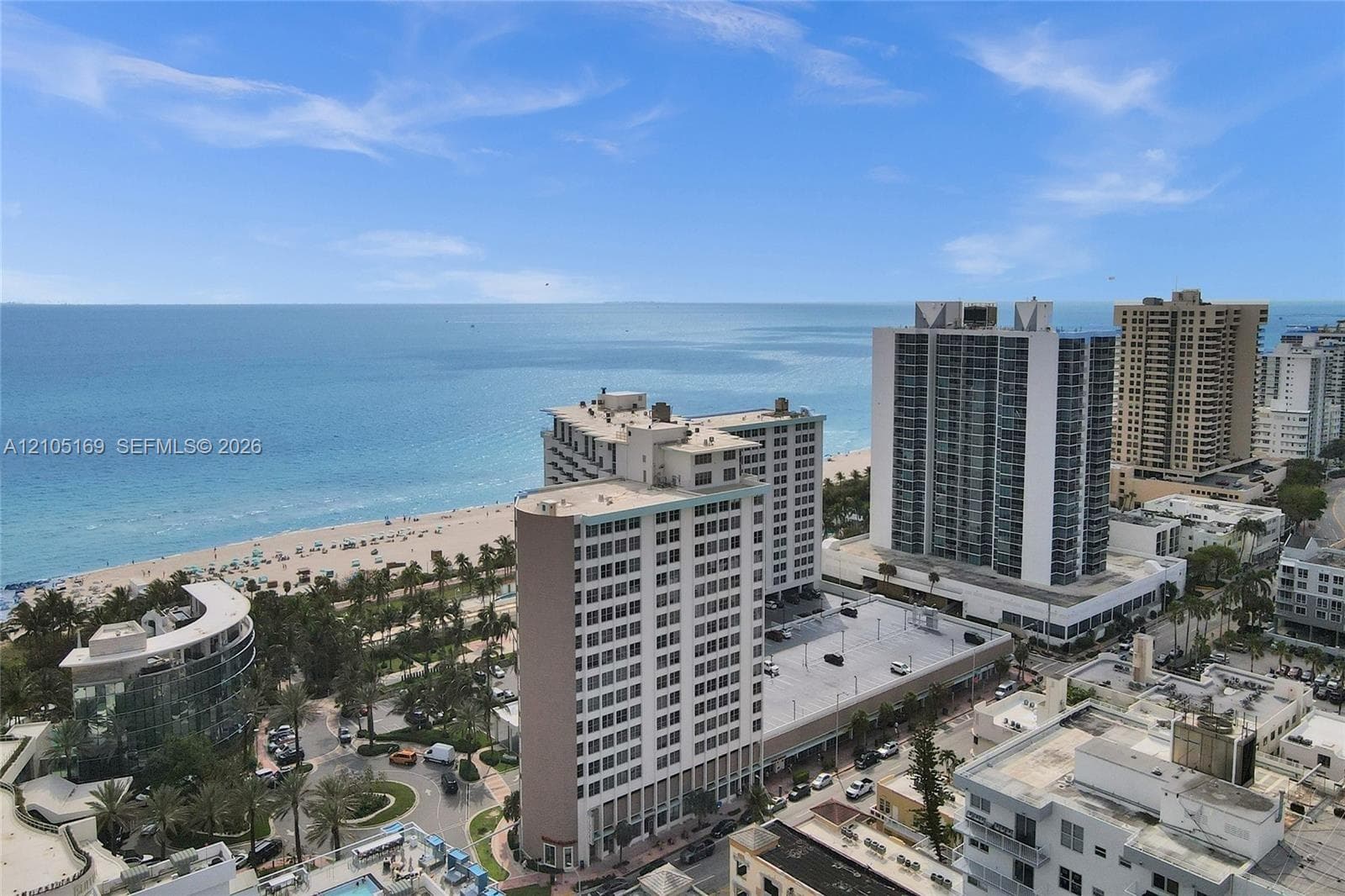Expansive ocean and beach scenery with a city backdrop