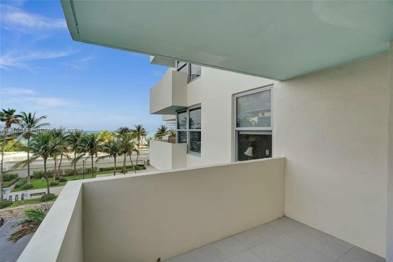 Balcony with tile flooring and a solid perimeter wall