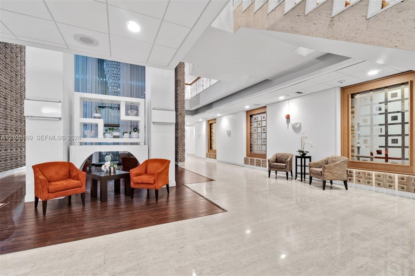 Polished tile flooring, wood-finish flooring, recessed lighting, and decorative wall panels