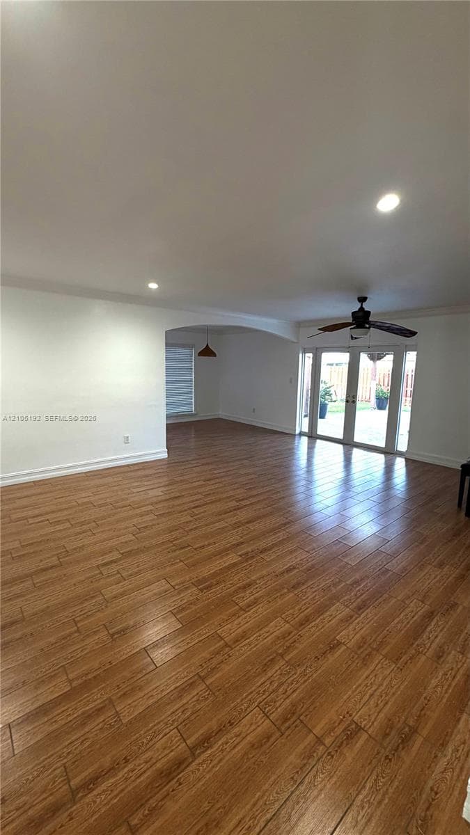 Wood-finish flooring, recessed lighting, and a ceiling fan