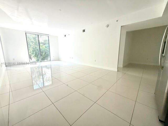 Large-format porcelain tile flooring, smooth ceilings with recessed lighting, and a floor-to-ceiling glass sliding door