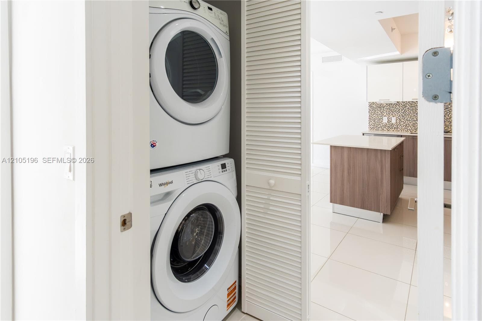 Stackable washer and dryer appliances within a louvered bifold door enclosure
