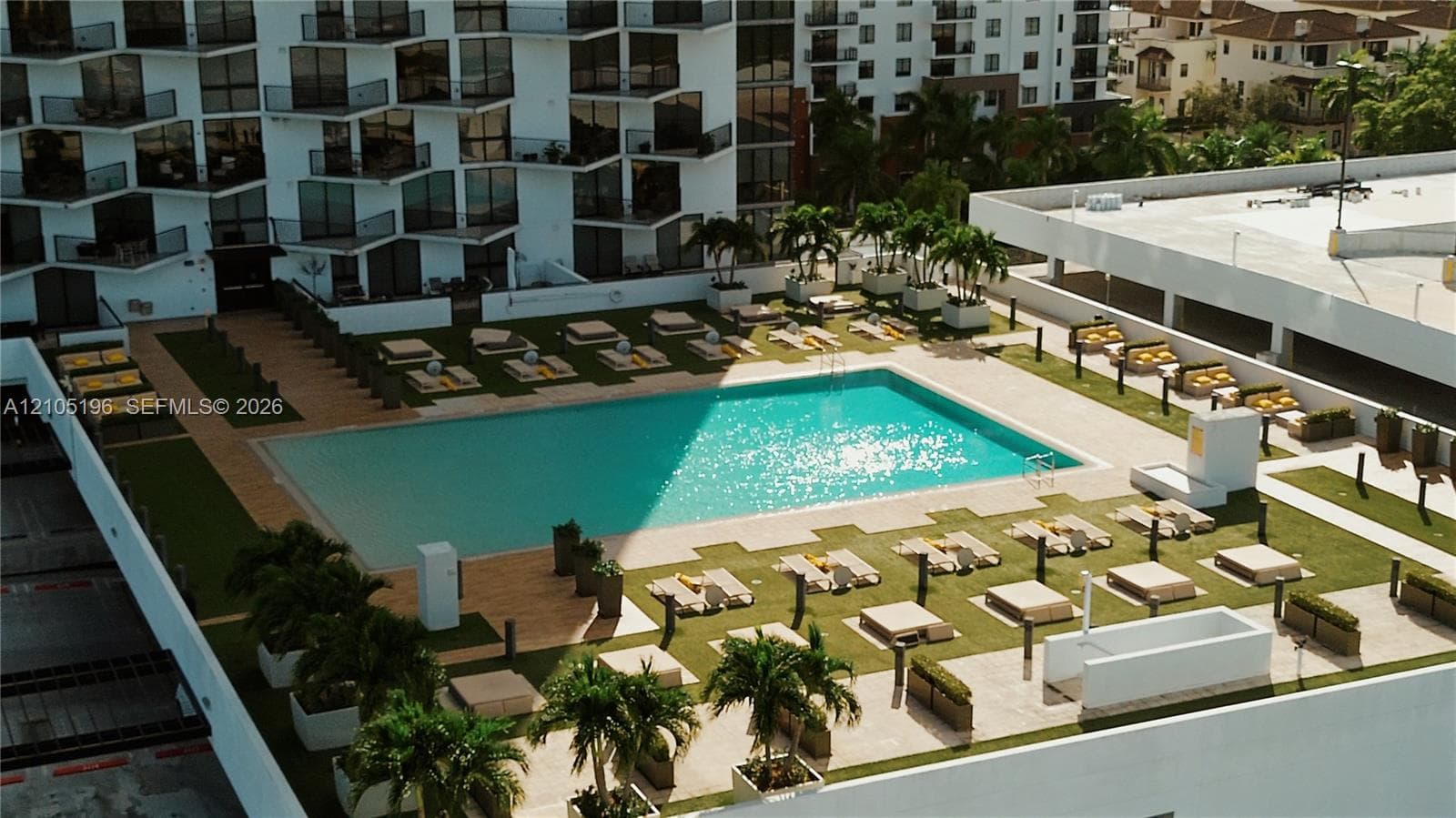 Rooftop amenity deck featuring a swimming pool, artificial turf, and integrated planting areas