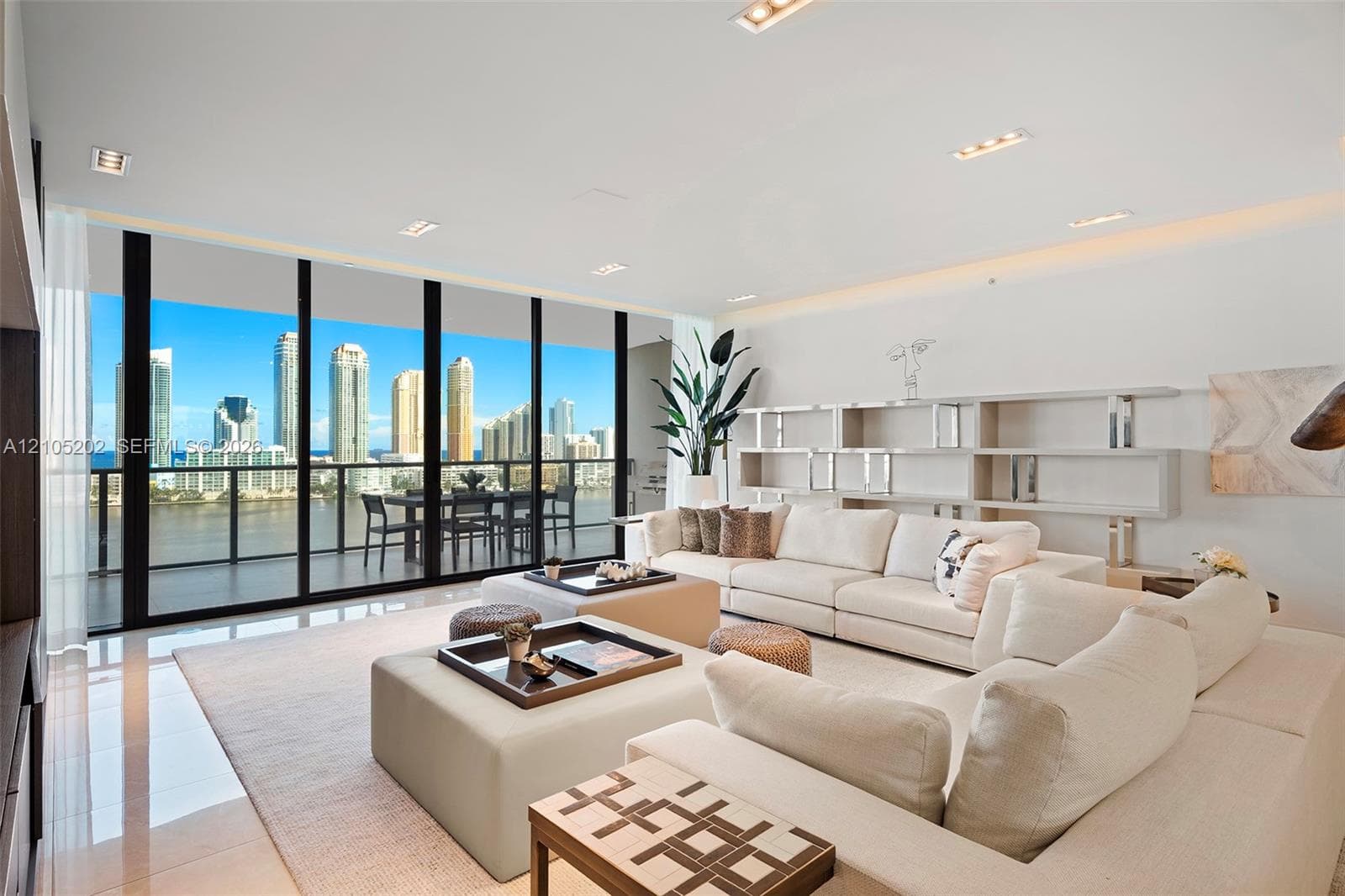 Floor-to-ceiling windows, polished tile flooring, built-in recessed shelving, recessed lighting, and a covered balcony