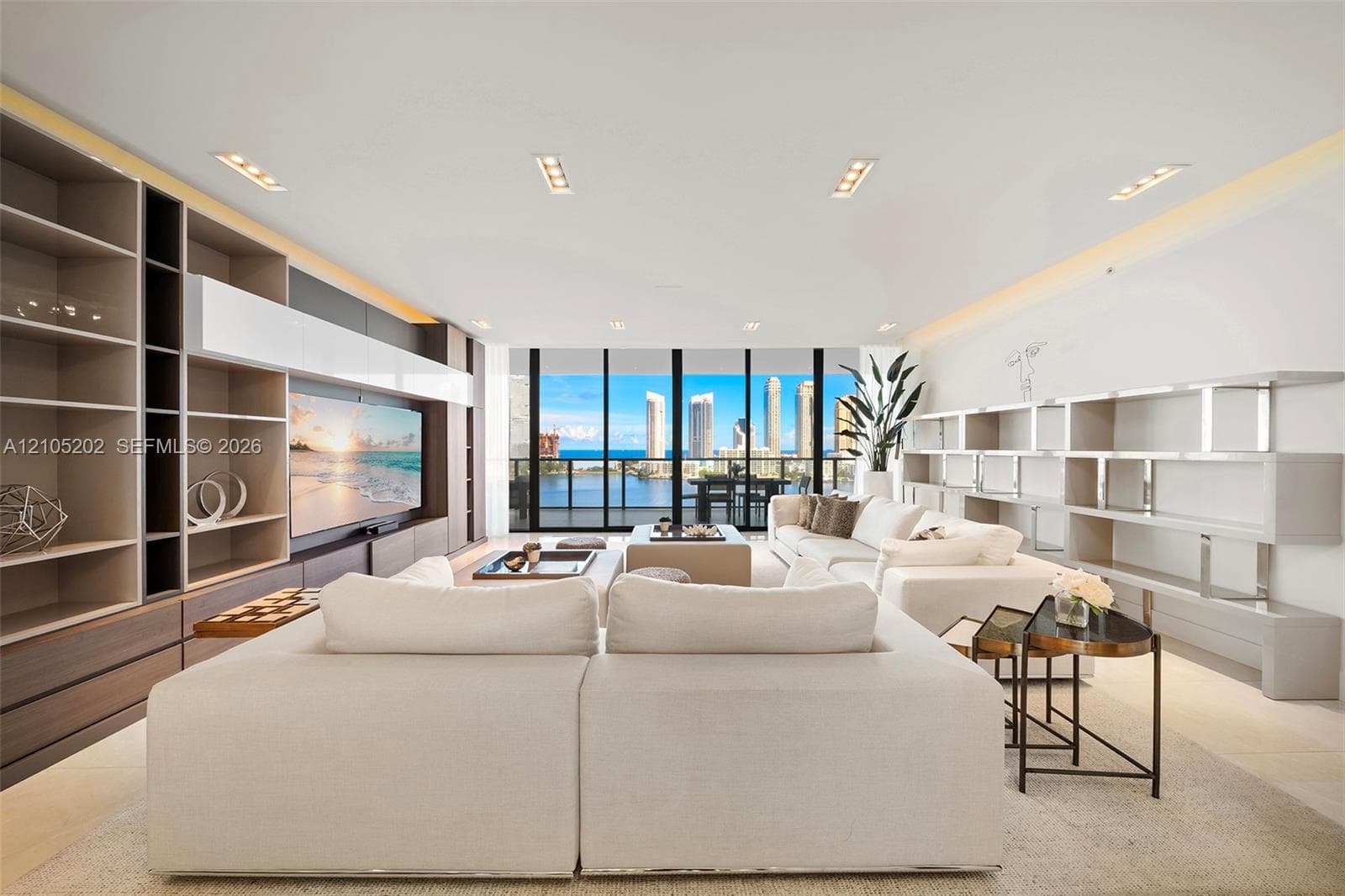 Floor-to-ceiling windows, custom built-in shelving, integrated recessed lighting, and wall-to-wall light-toned flooring