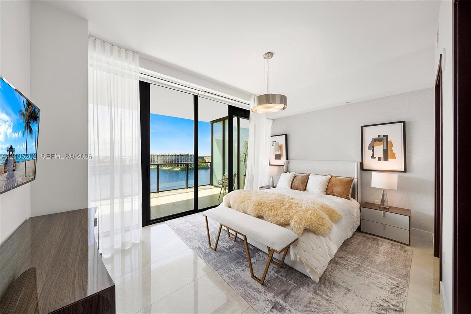 Floor-to-ceiling glass sliding doors opening to a balcony, polished tile flooring, pendant lighting, and neutral wall tones