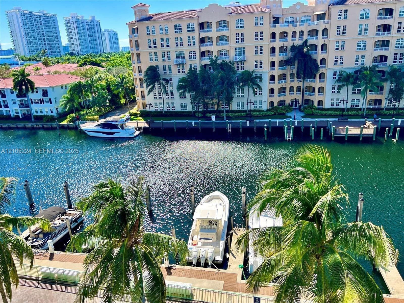Waterfront building with private boat docks and surrounding urban landscape