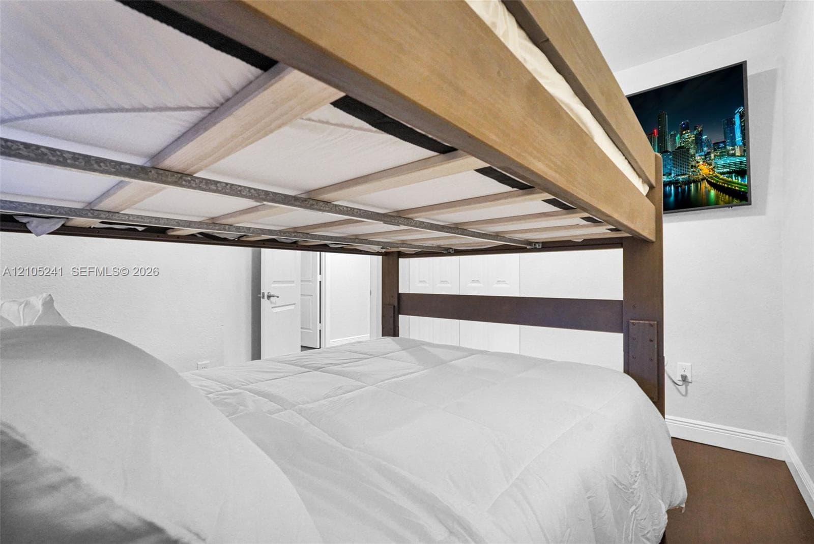 Built-in bunk bed with wood-finish framing and integrated shelving