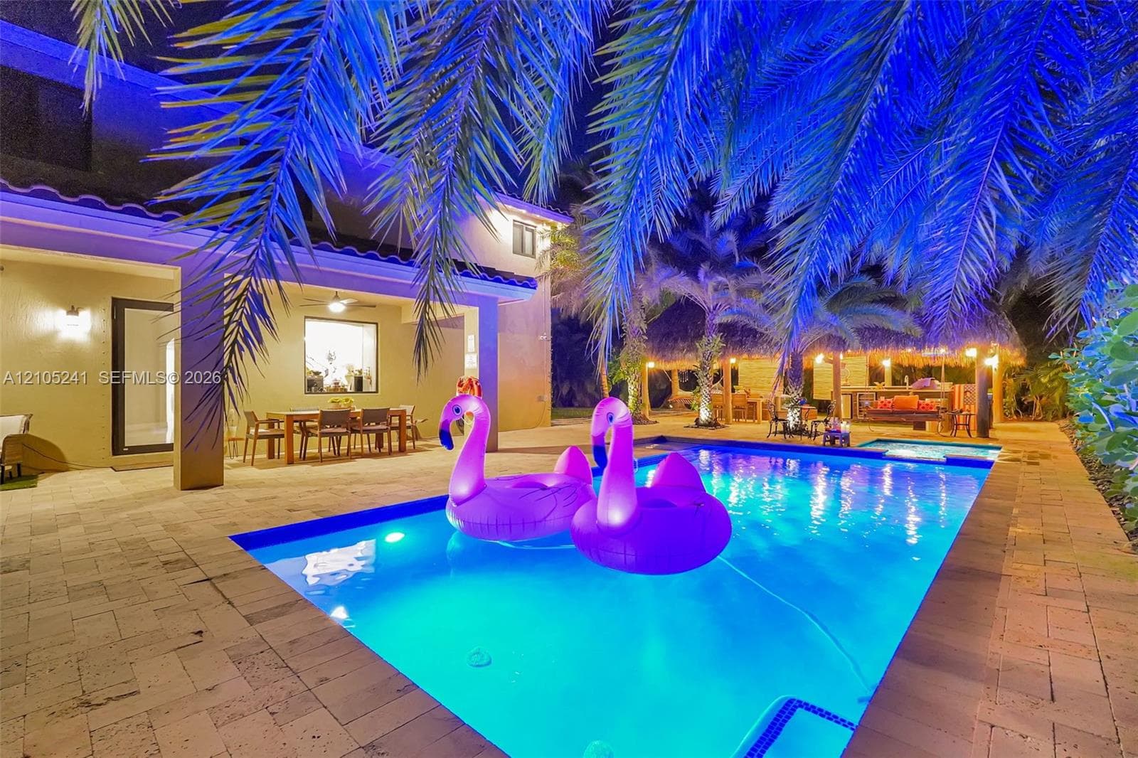 Rectangular swimming pool with integrated spa, surrounded by paver decking