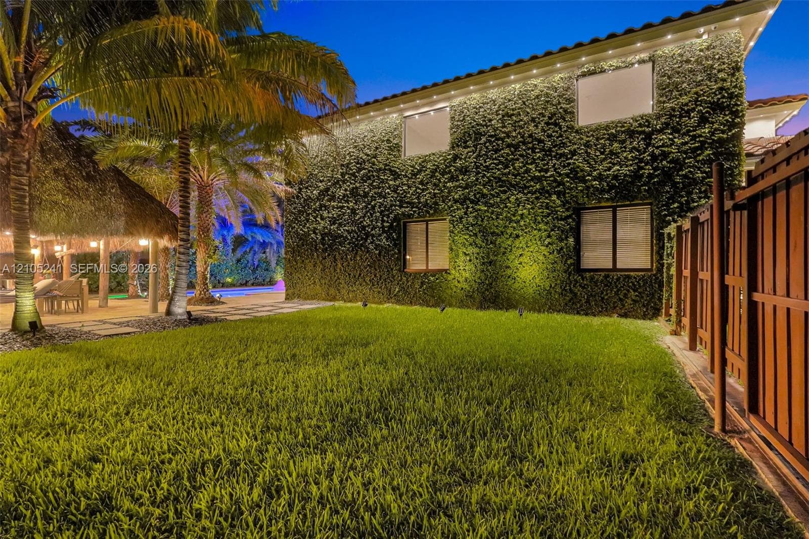 Lush green lawn with a privacy fence