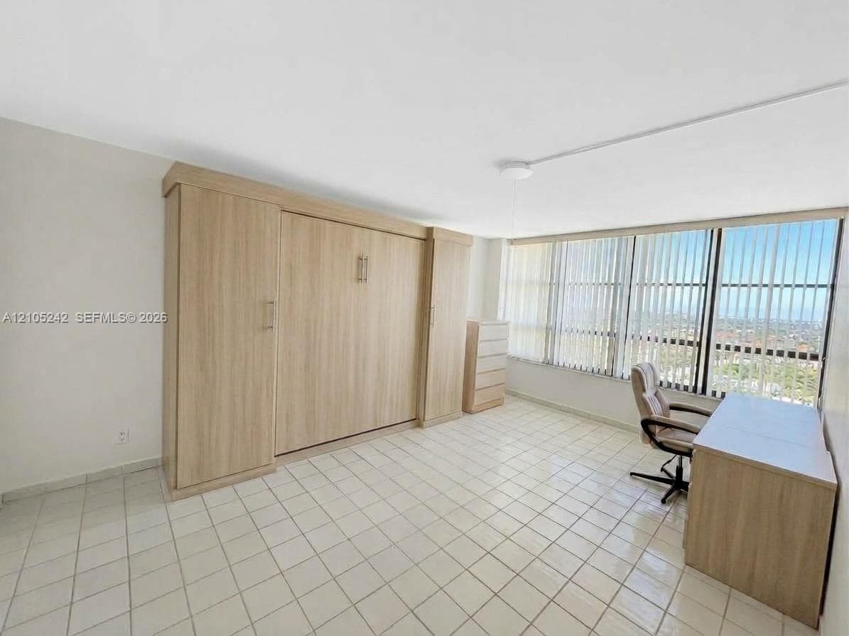 Built-in cabinetry with wood-finish, full-height windows with vertical blinds, tile flooring, and recessed ceiling lighting