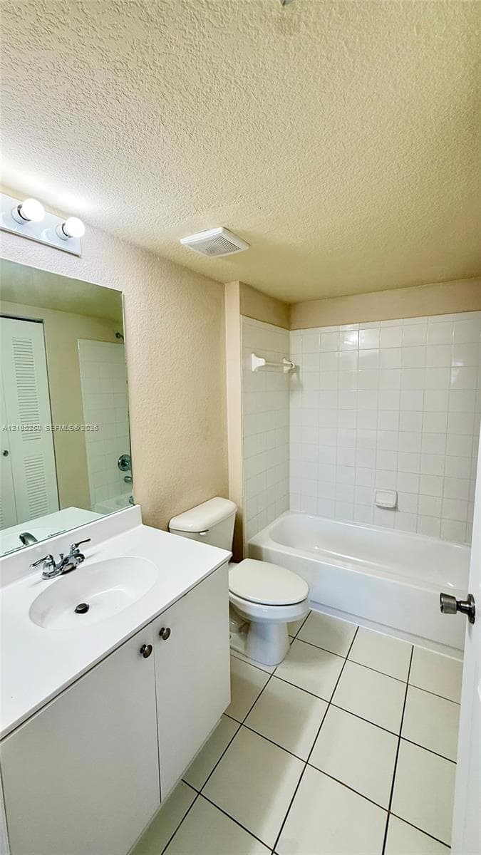 Bathroom featuring a vanity with a laminate countertop, integrated sink, and an overhead mirror