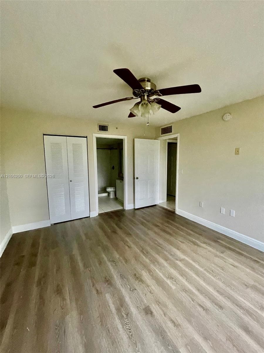 Wood-finish flooring throughout, paired with a ceiling fan light fixture