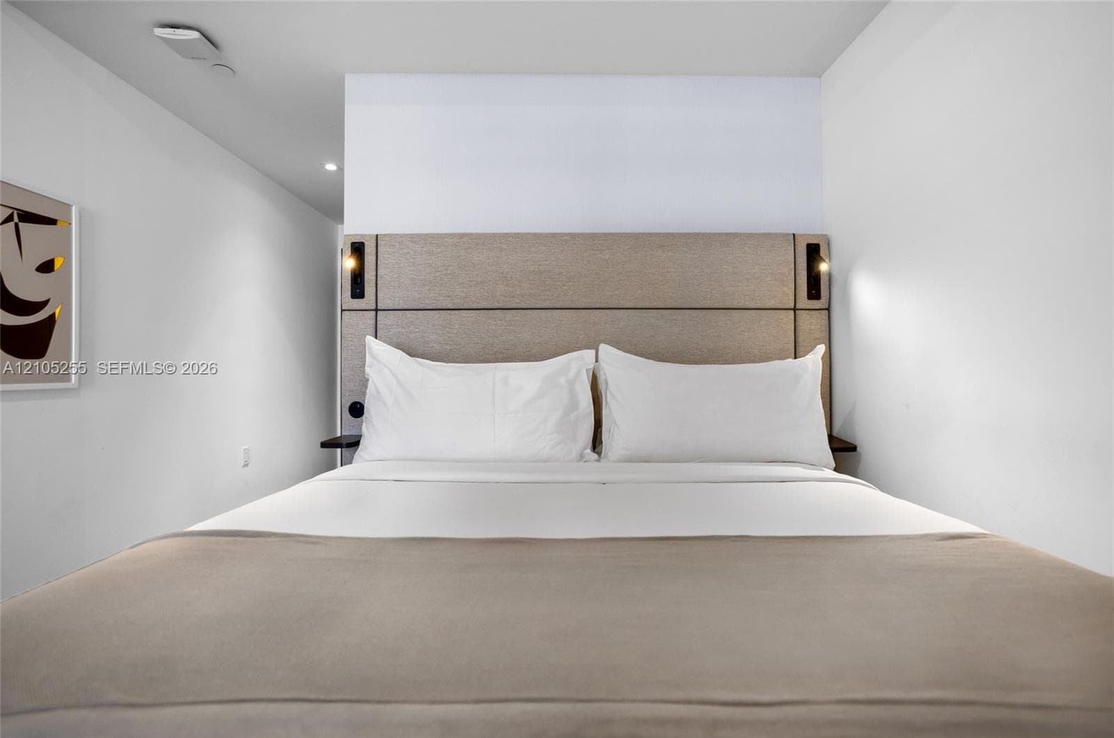 Integrated custom headboard featuring dual built-in reading lights and floating side shelves