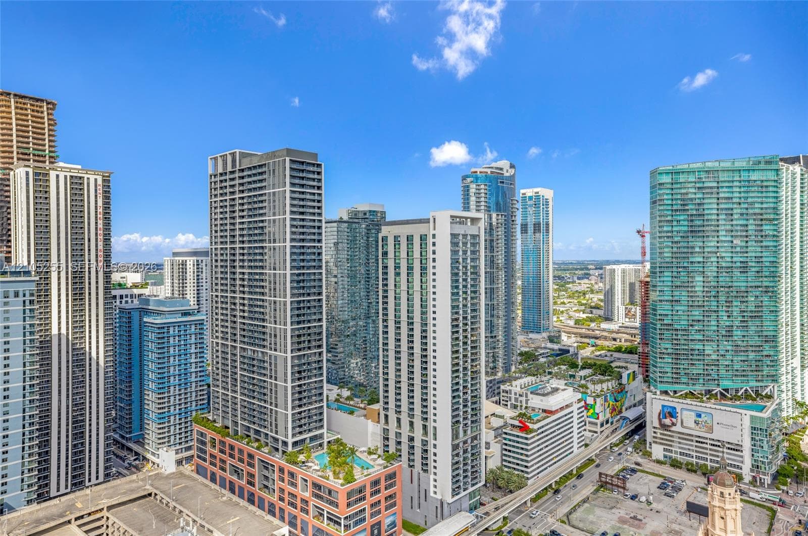 High-rise urban landscape featuring glass curtain wall construction, expansive floor-to-ceiling windows, and integrated rooftop terrace amenities