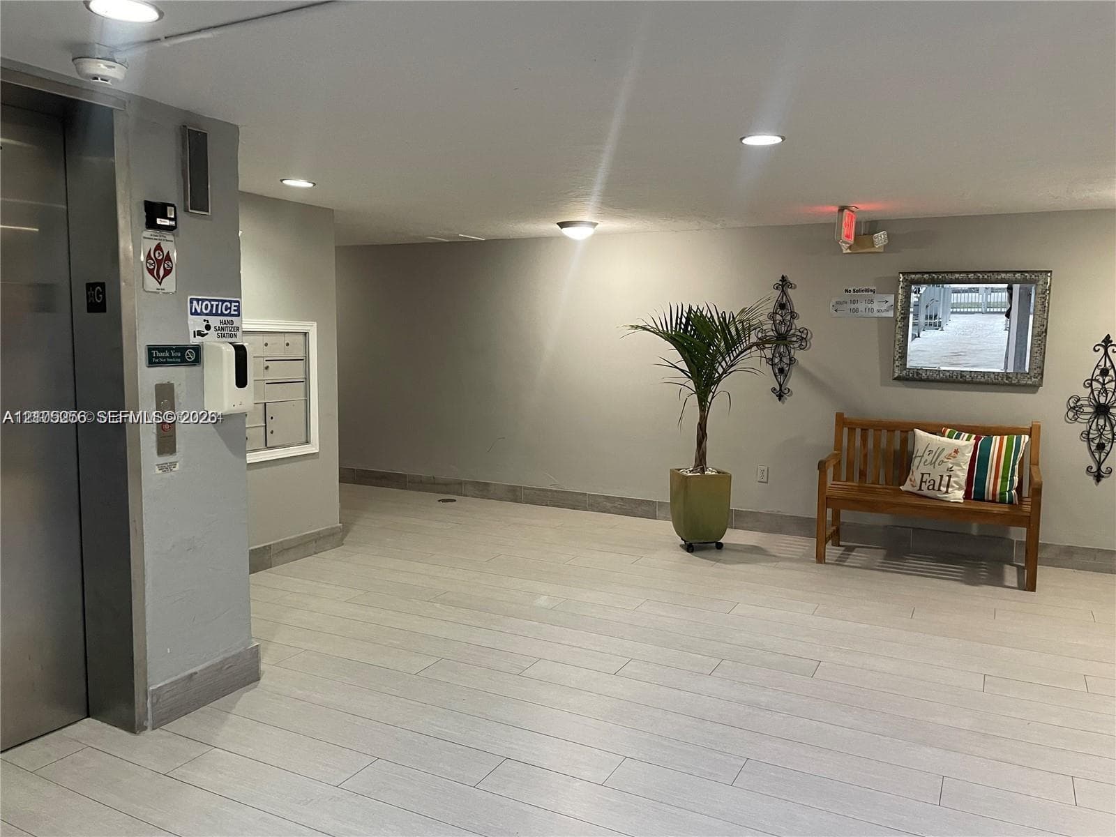 Building lobby featuring porcelain tile flooring, recessed ceiling lighting, a metallic elevator door, and integrated wall-mounted mailboxes