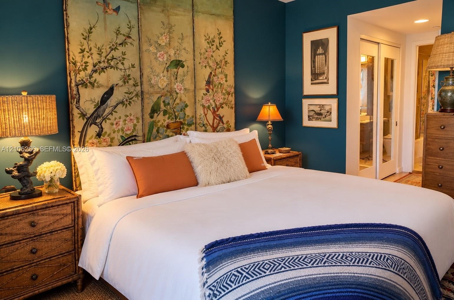 Room featuring deep teal wall paint, dual white sliding-panel closet doors with glass inserts, and recessed ceiling lighting