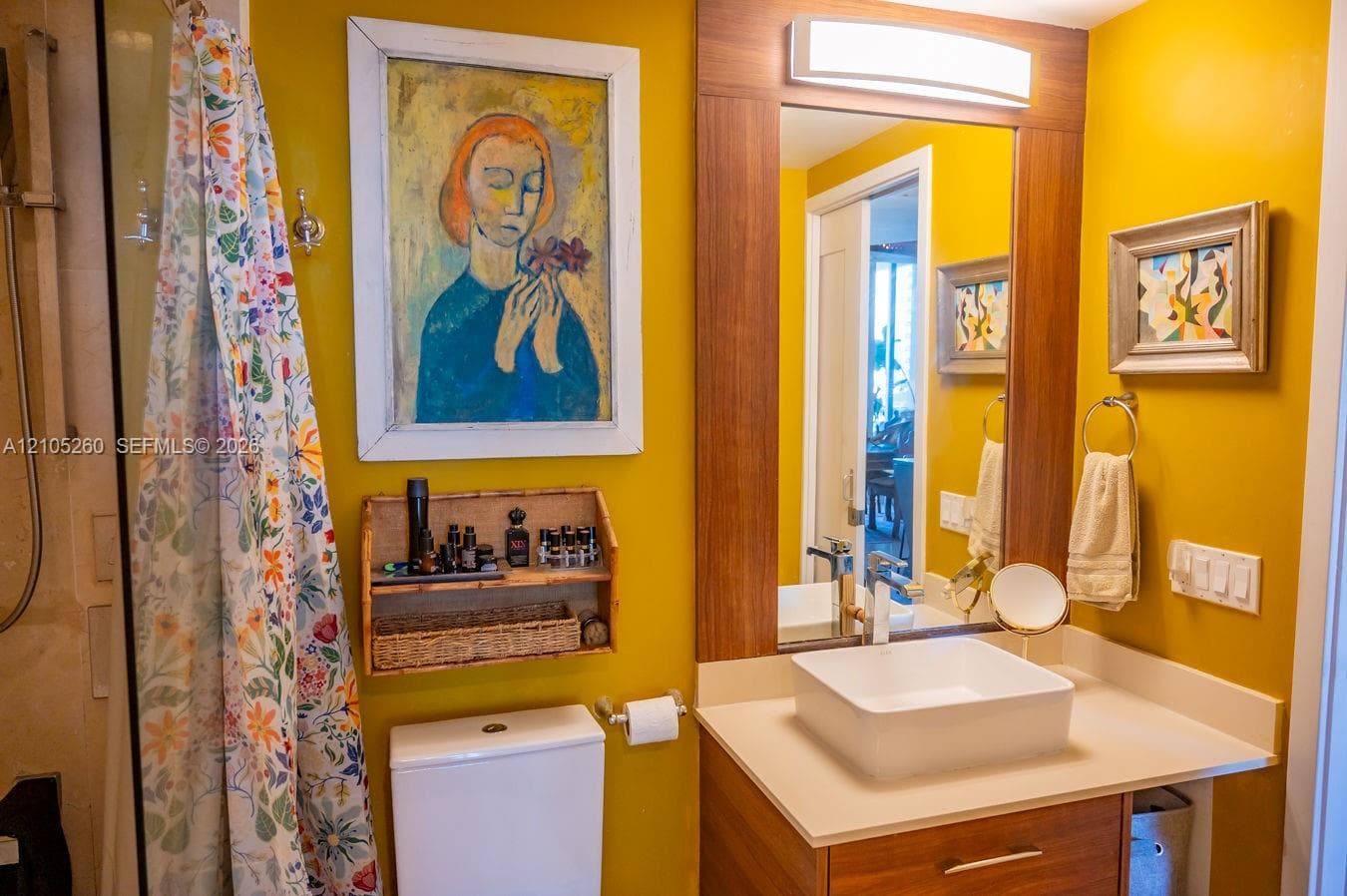 Modern vanity with a rectangular vessel sink, polished chrome faucet, and wood-finish cabinetry
