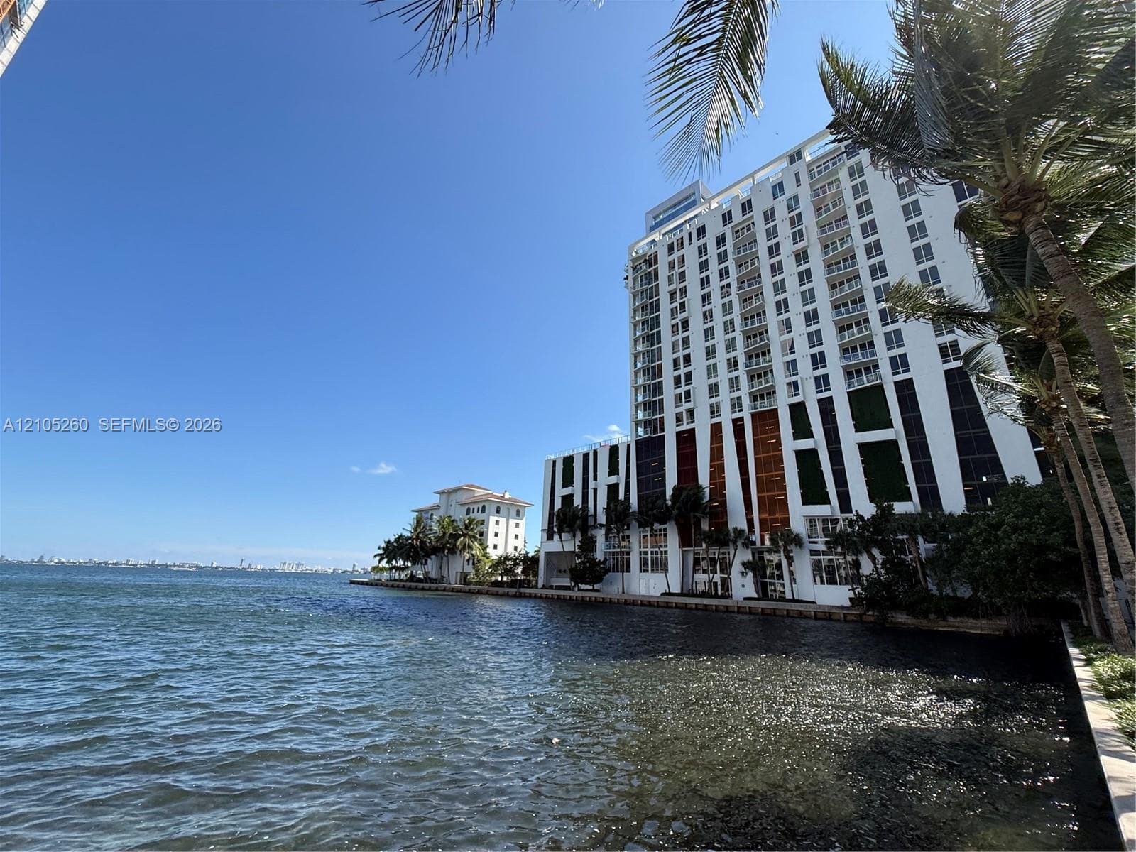 Waterfront high-rise building featuring private balconies, floor-to-ceiling windows, and direct water access