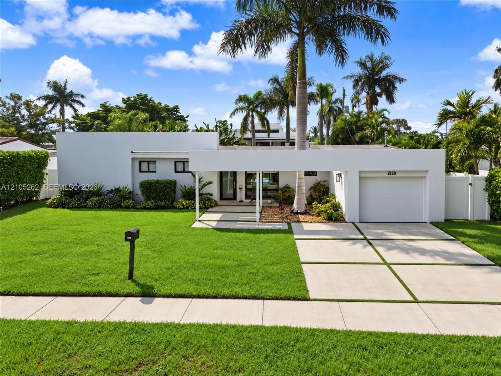 Modern exterior architecture with a flat roofline, integrated single-car garage, and a covered entryway