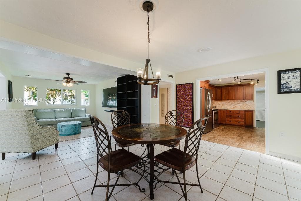 Tile flooring throughout, recessed lighting, and a built-in shelving unit