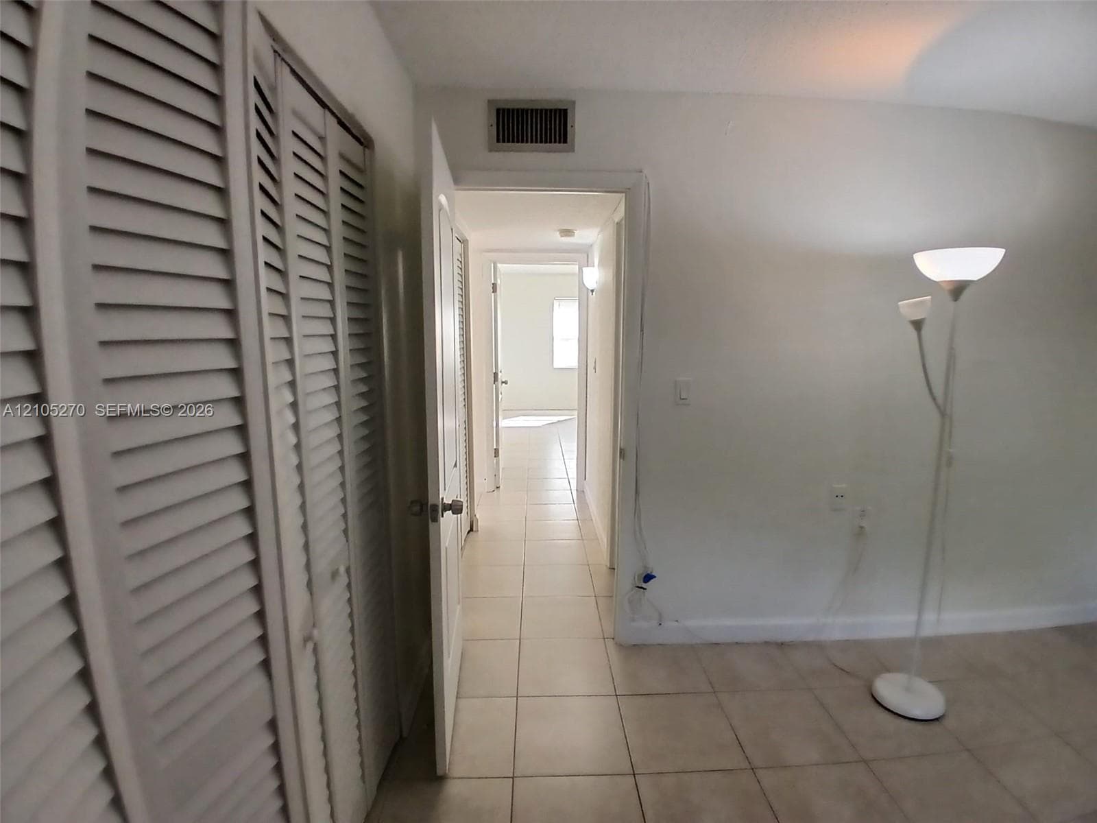 Tiled flooring throughout, louvered bi-fold doors, and a neutral wall palette