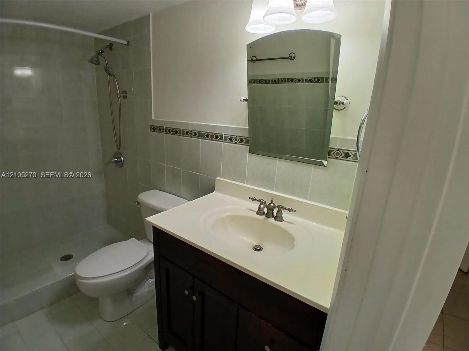 Dark wood-finish vanity with an integrated sink and brushed nickel faucet