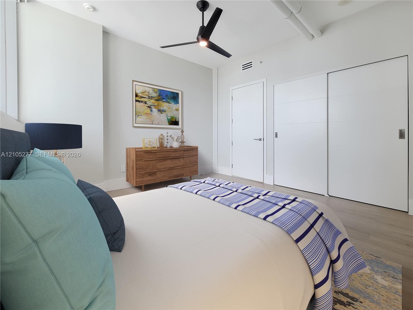Recessed lighting, ceiling fan, wood-finish flooring, white walls, and built-in sliding closet doors