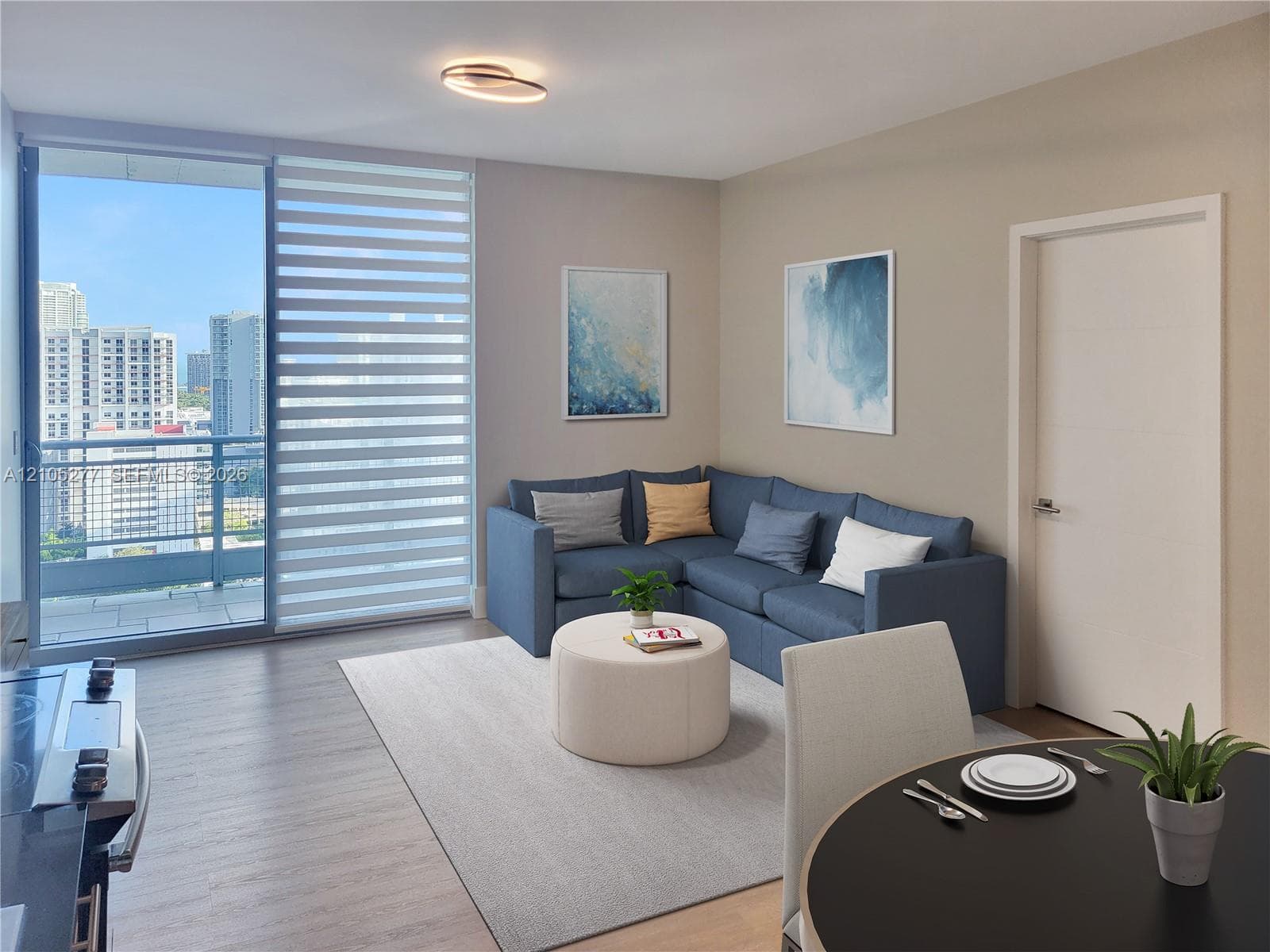 Open concept living area with wood-finish flooring, sliding glass door to a balcony, ceiling-mounted light fixture, and neutral wall tones