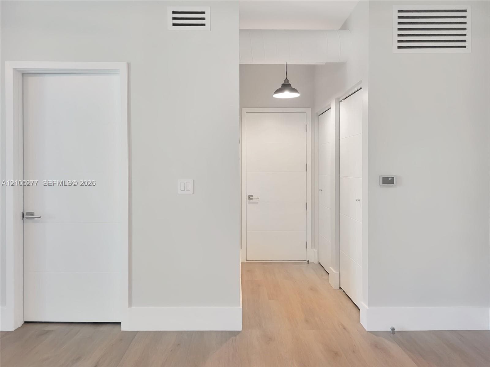 Wood-finish flooring with white baseboards