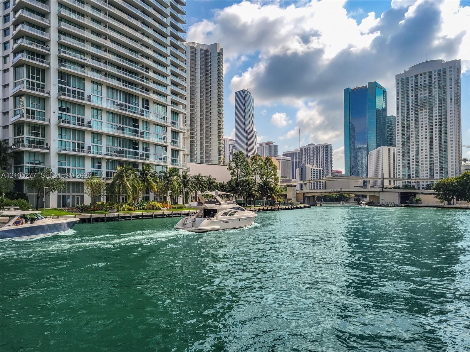 Waterfront property featuring a prominent high-rise building with multiple balconies