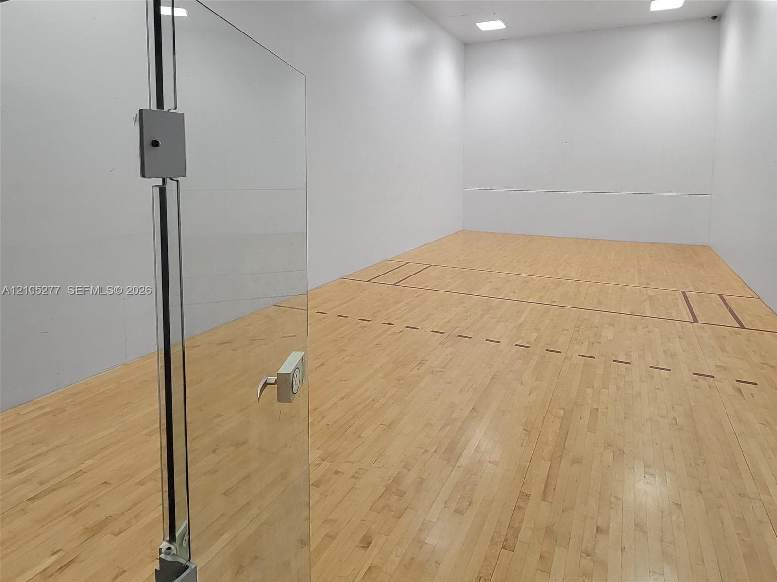 Private indoor court featuring hardwood flooring and designated court lines