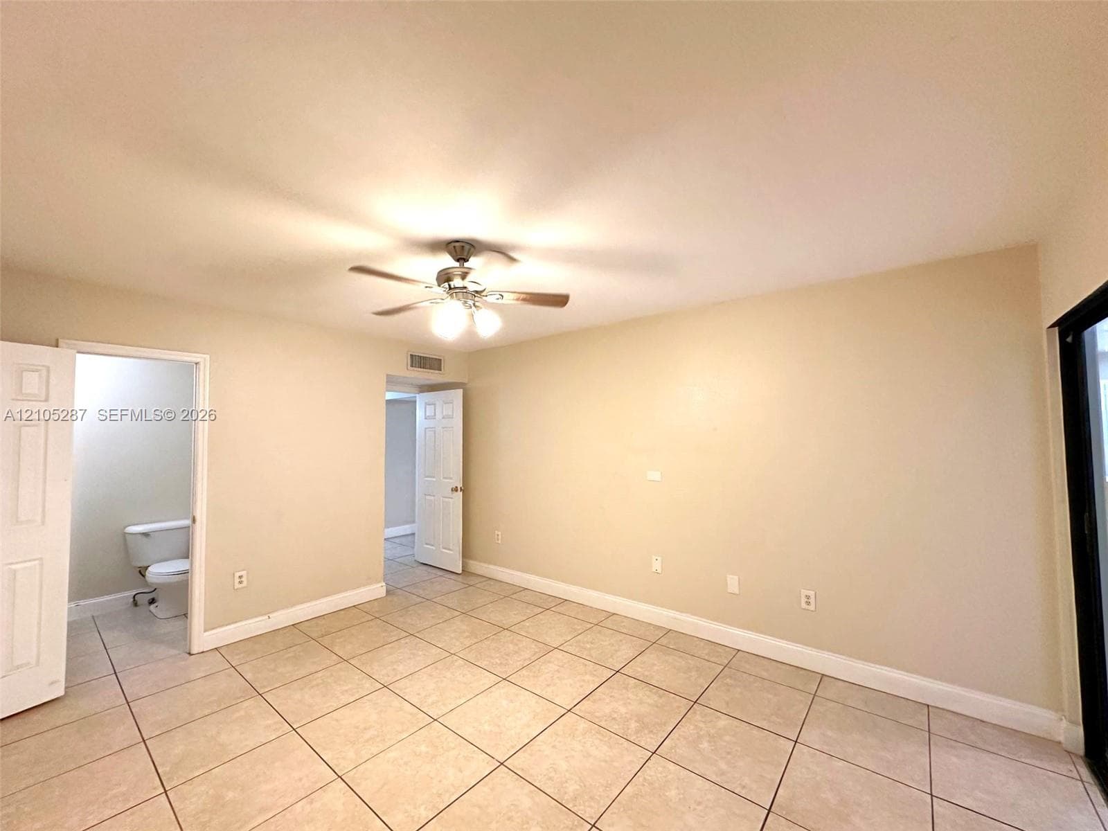 Tile flooring, ceiling fan with integrated lighting, and a sliding glass door