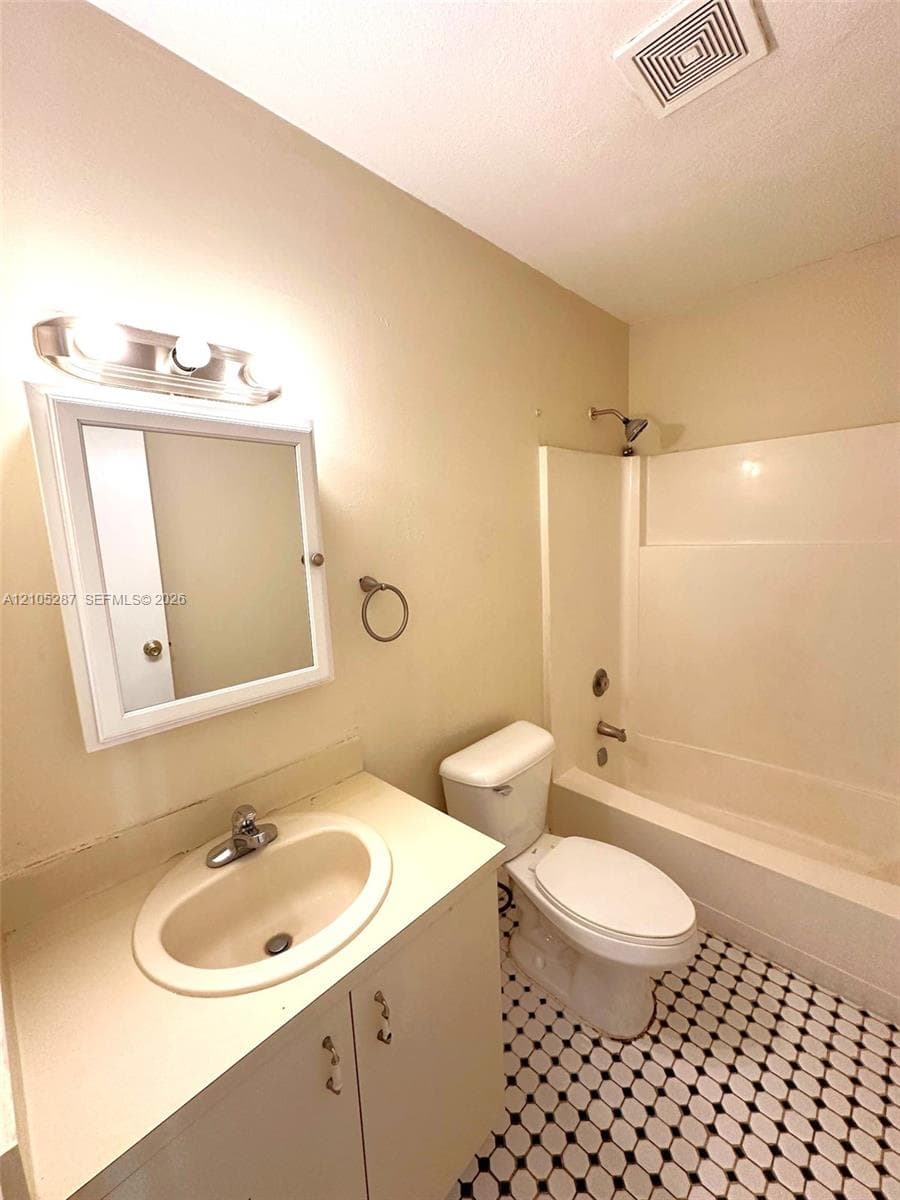 White vanity with an integrated sink, polished chrome faucet, and storage cabinetry