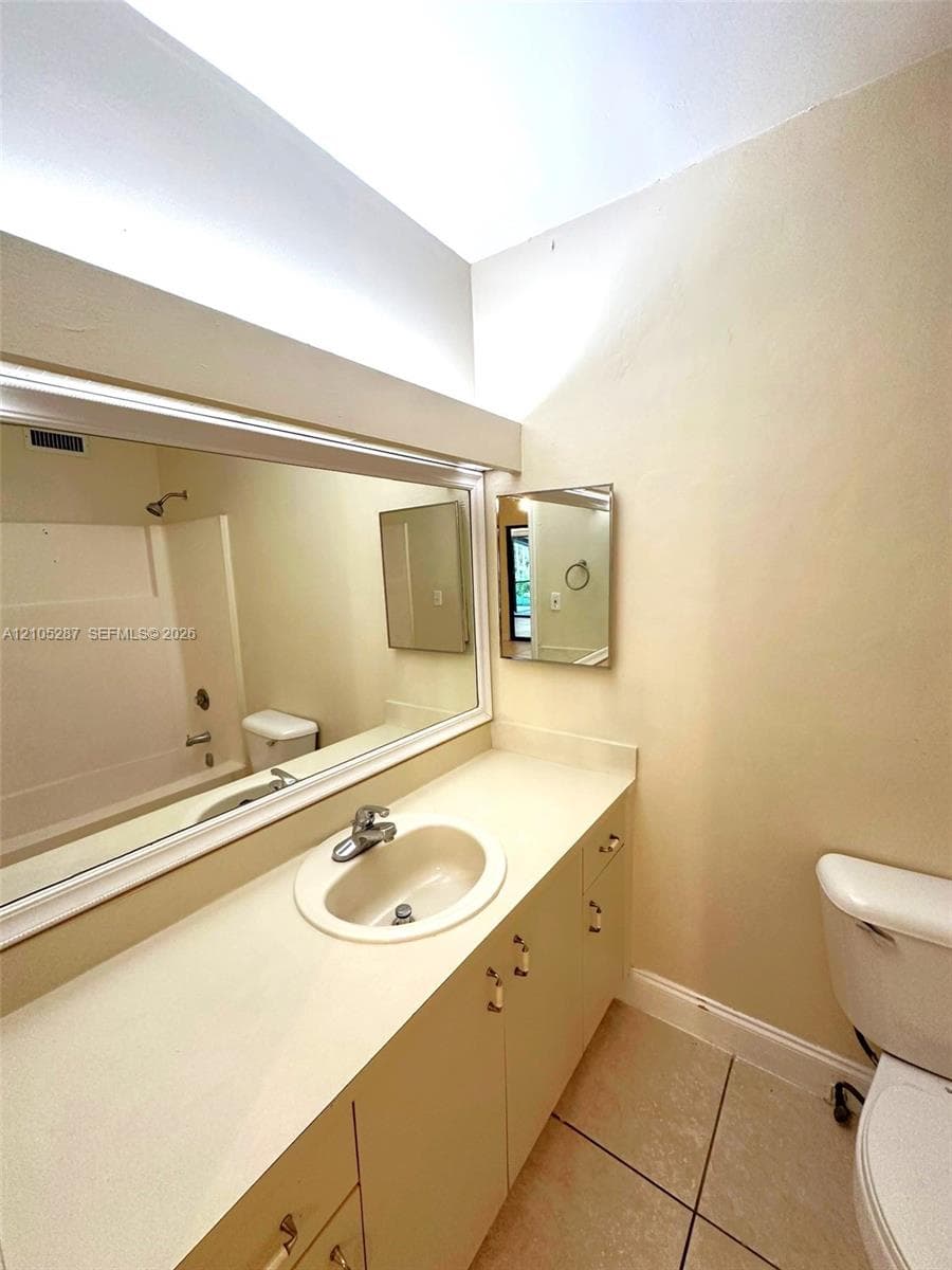 Vanity with an integrated sink, polished chrome faucet, and ample counter space