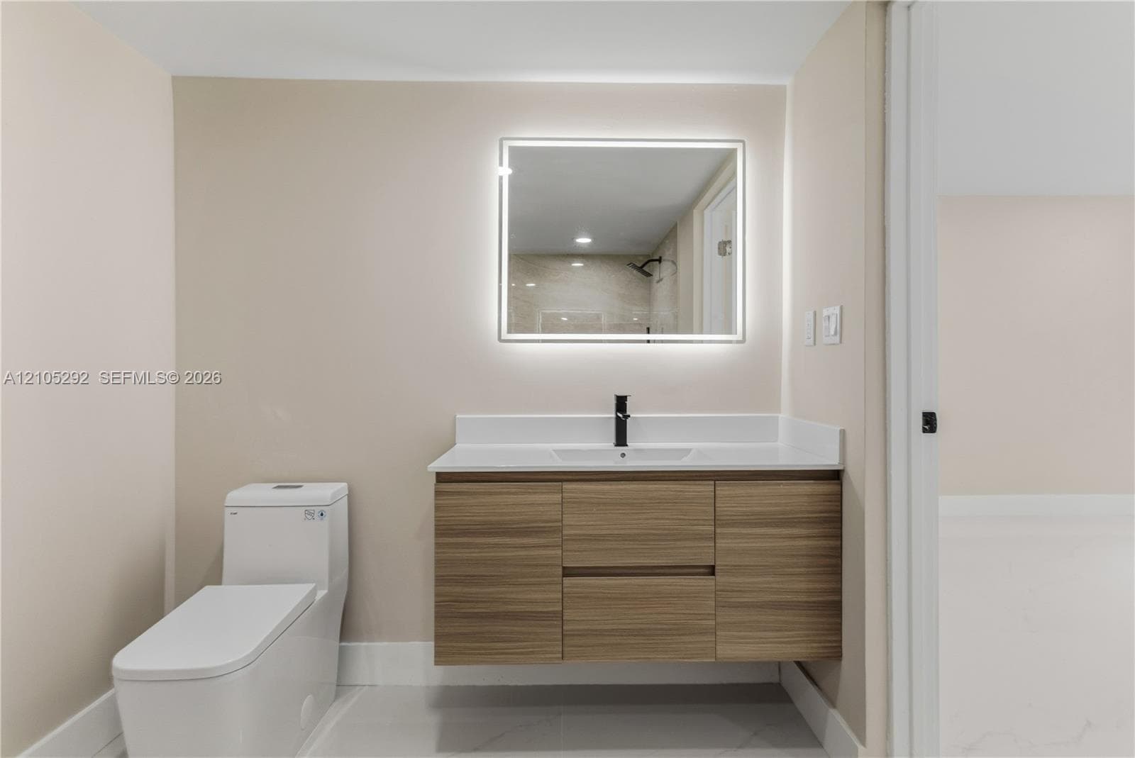 Floating wood-finish vanity with a white countertop and rectangular sink